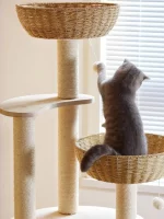 A cat is playing with this little ball of this wood cat tower.