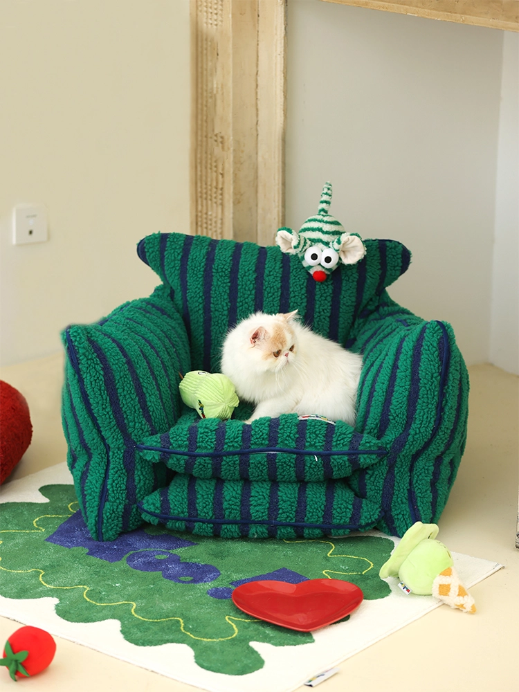 A furry cat sits on a striped sherpa cat sofa bed.
